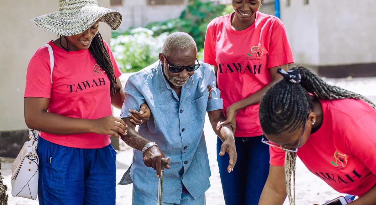 young people helping an old person