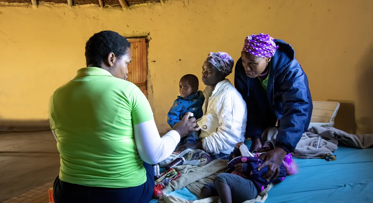 Woman undergoing a physical examination on a child