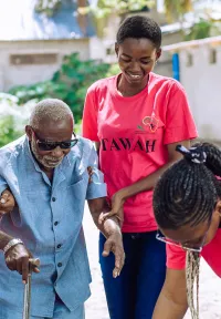 young people helping an old person