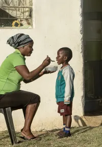 Woman feeding child